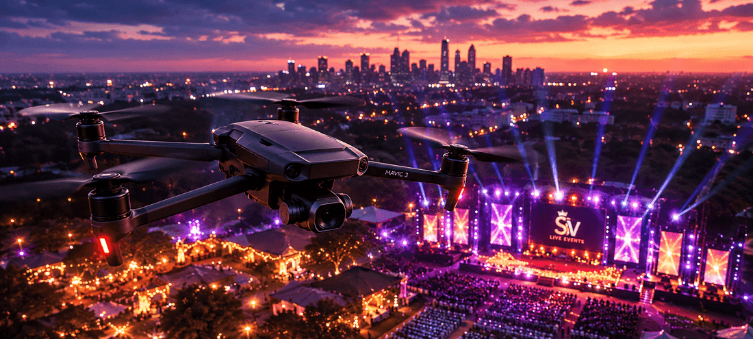 Drone aerial view of a lit outdoor event stage at dusk